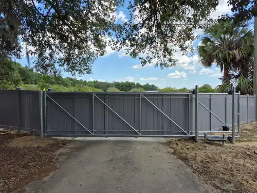 Dark composite dog run fence with an electric gate in Altamonte Springs