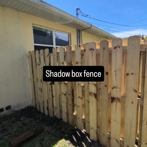 Wood shadow box fence next to a yellow home in Orlando